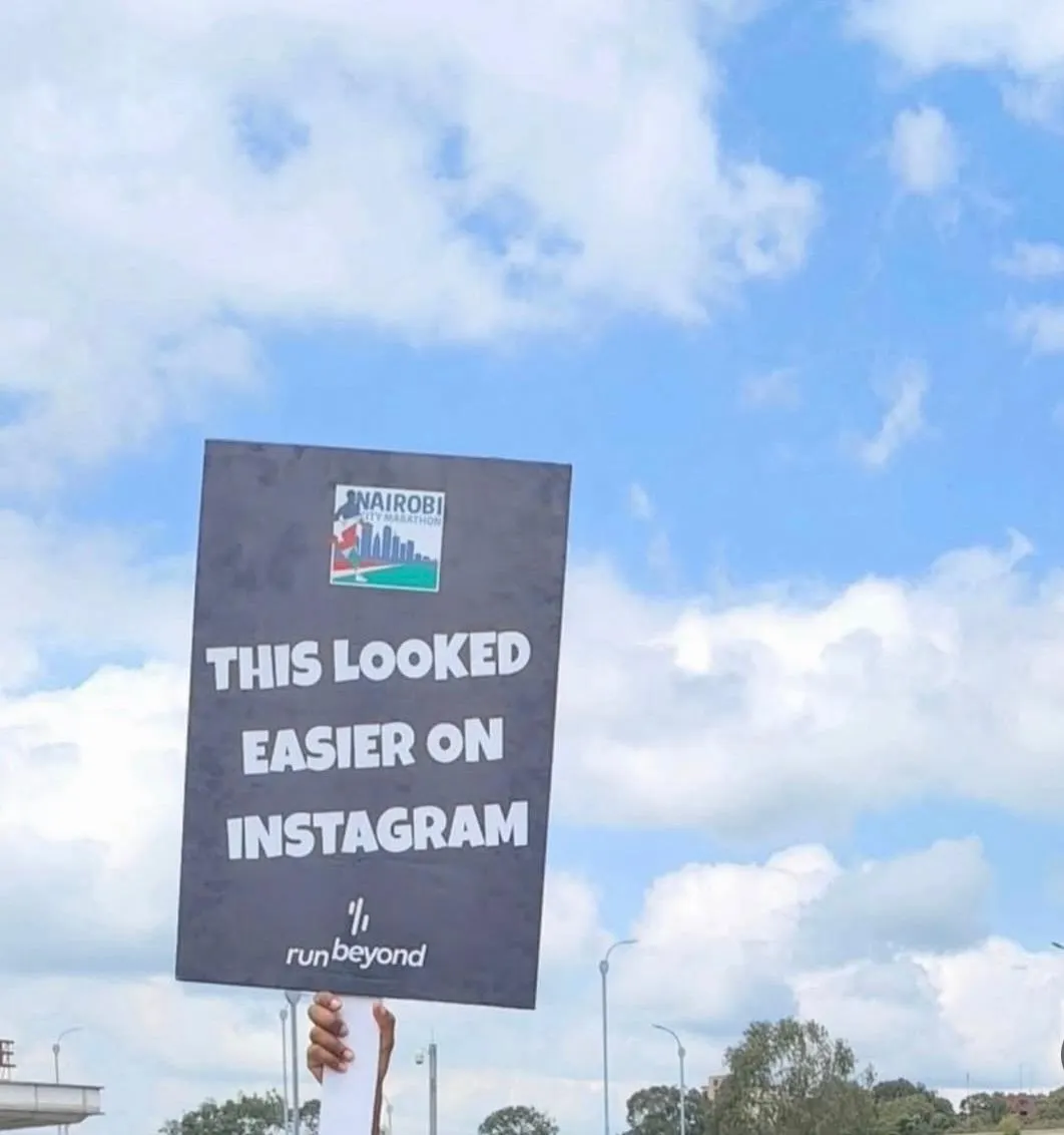 A handwritten sign held up along the Nairobi City Marathon route
